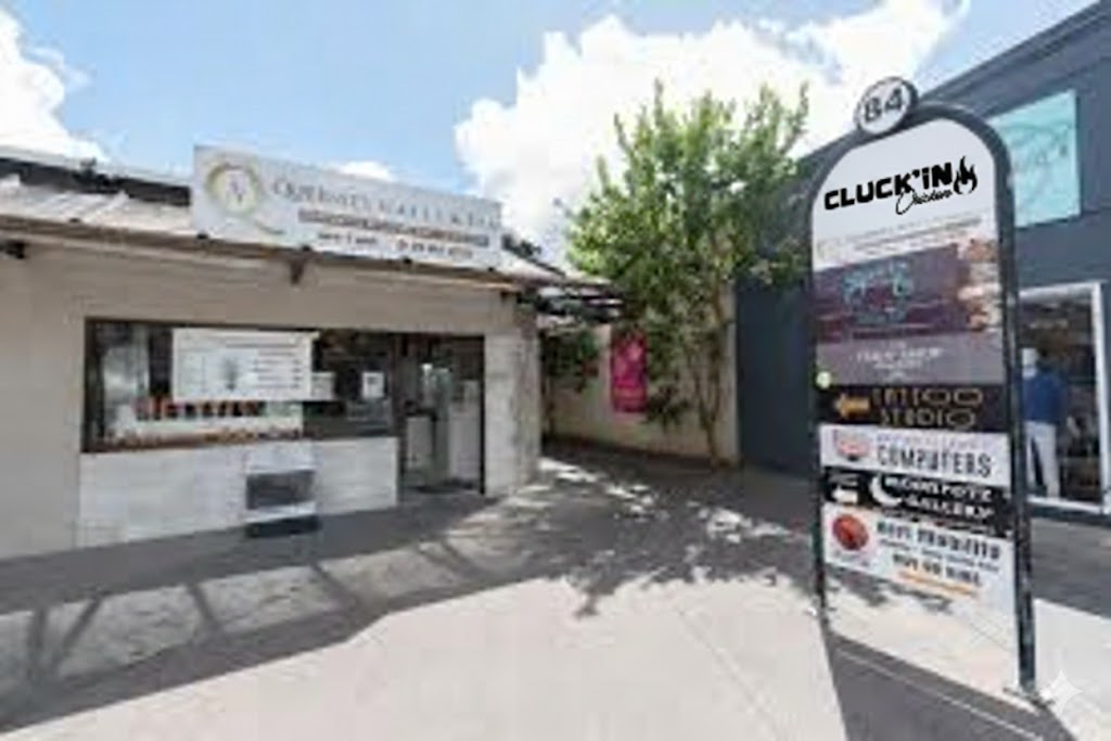 Cluck'in Chicken Restaurant Sign